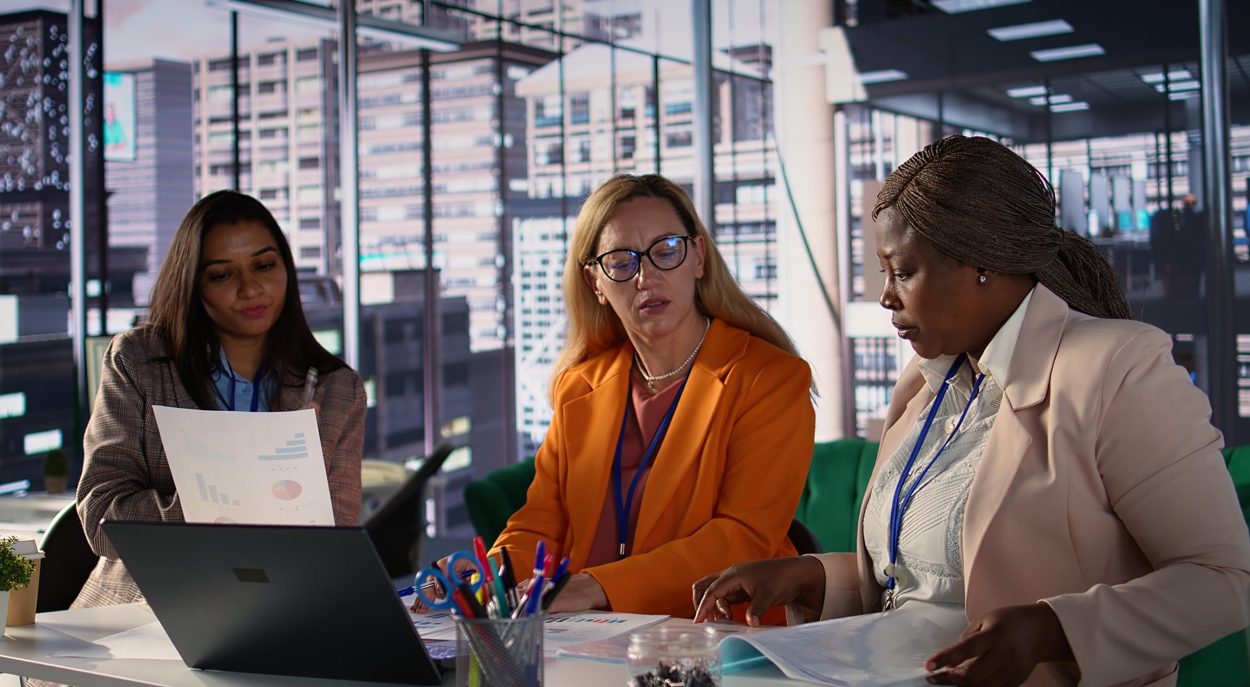 Two professionals collaborating at a workstation on compliance information