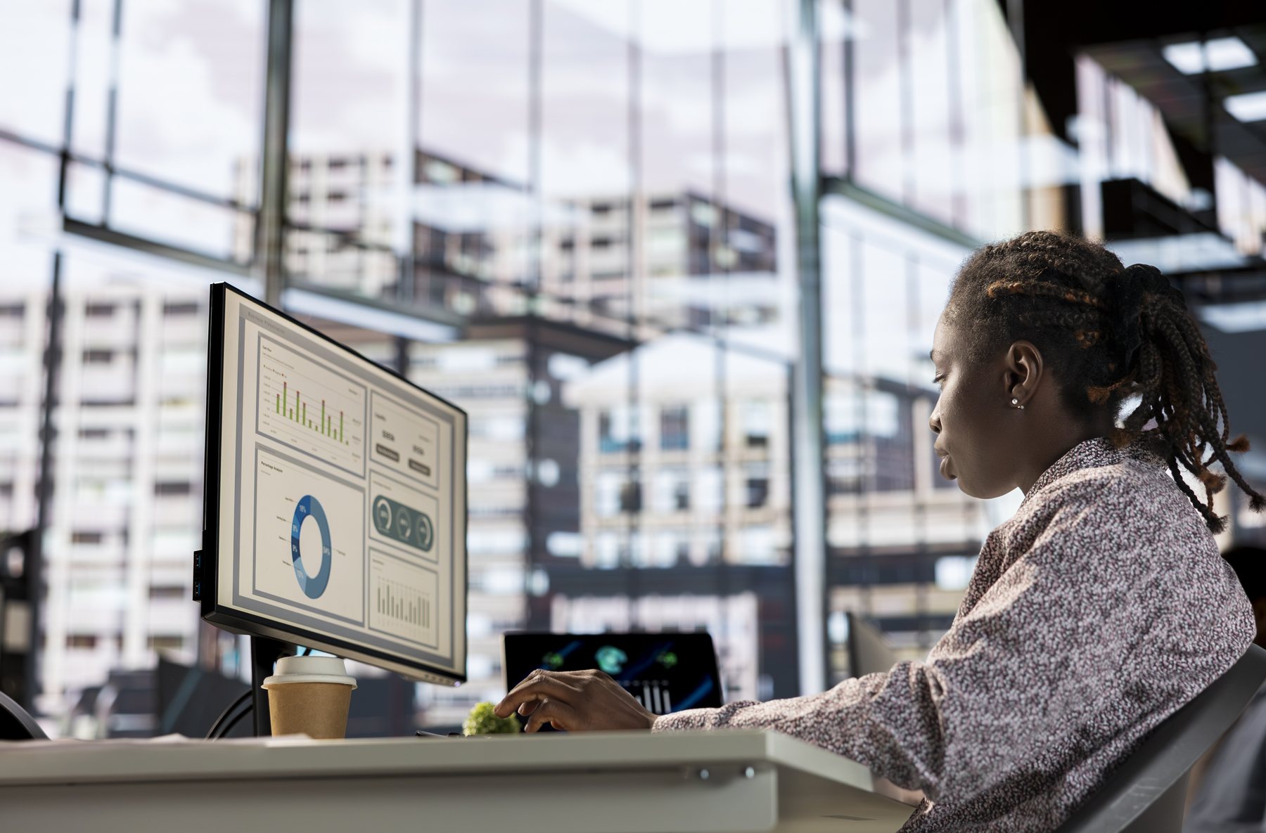 Financial professional analysing reporting dashboards on a computer screen